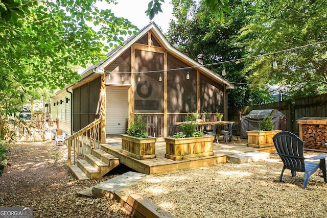 rear view of property with a sunroom