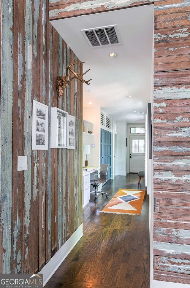 hallway with dark hardwood / wood-style flooring