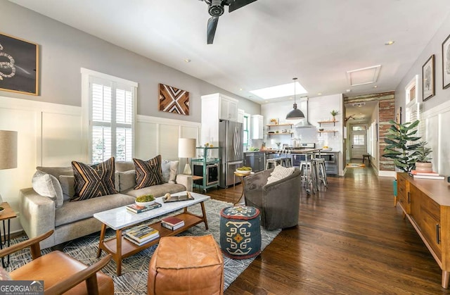 living room featuring ceiling fan and dark wood-type flooring