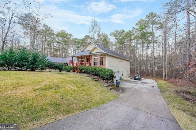 view of side of property with a garage, a lawn, and covered porch