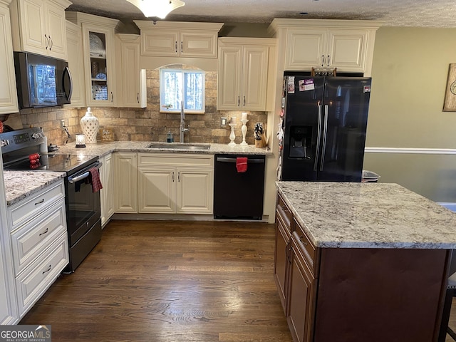 kitchen with sink, white cabinets, dark hardwood / wood-style floors, and black appliances