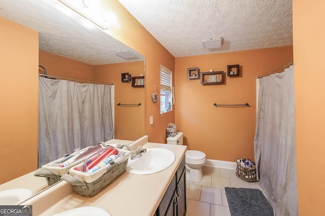 bathroom with curtained shower, vanity, toilet, tile patterned floors, and a textured ceiling