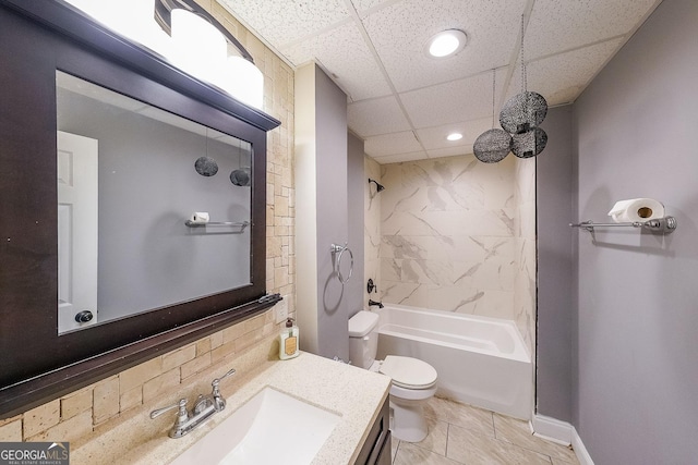 full bathroom with tiled shower / bath, vanity, toilet, and a drop ceiling