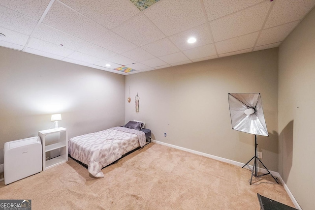 carpeted bedroom with a drop ceiling