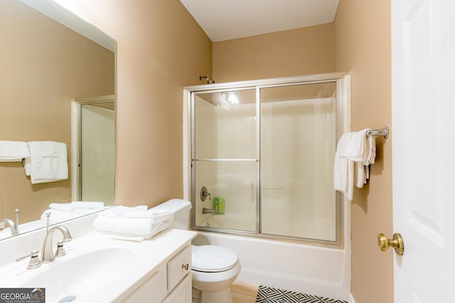 full bathroom with tile patterned flooring, toilet, vanity, and combined bath / shower with glass door