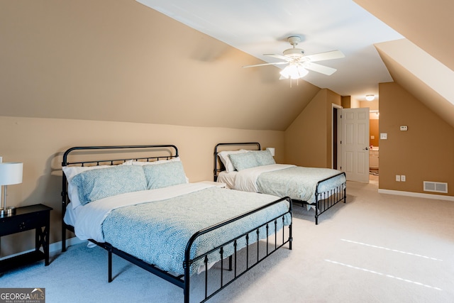 carpeted bedroom with ceiling fan and vaulted ceiling