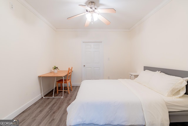 bedroom featuring hardwood / wood-style floors, ceiling fan, and crown molding