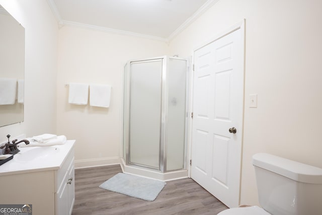 bathroom featuring walk in shower, crown molding, vanity, and hardwood / wood-style flooring