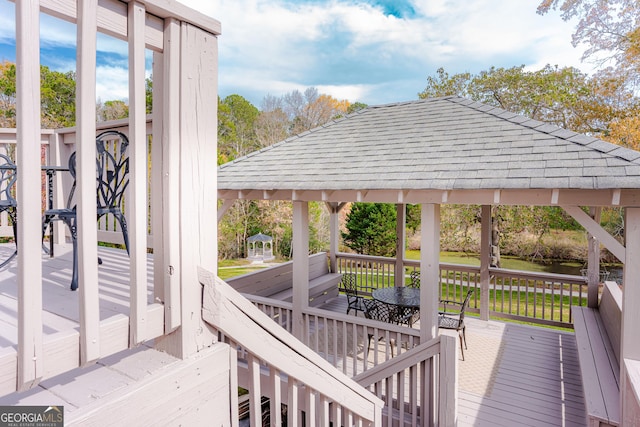 deck with a gazebo and a water view