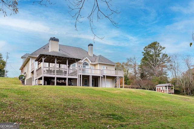 rear view of house featuring a lawn and a wooden deck