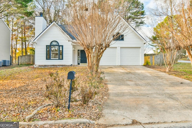 view of front of house with a garage and central air condition unit