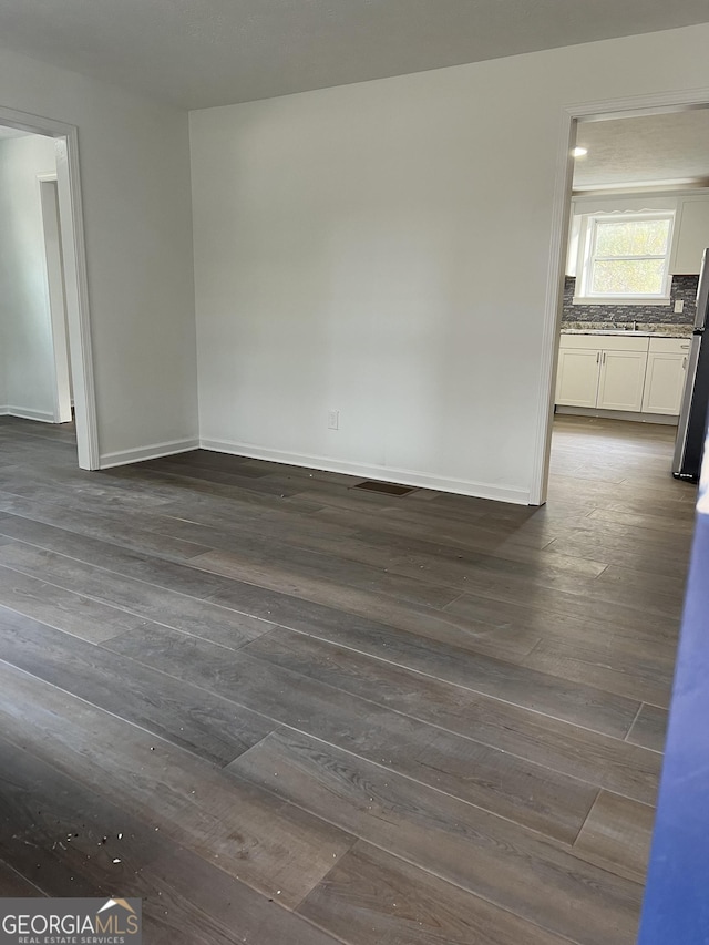 empty room with dark wood-type flooring