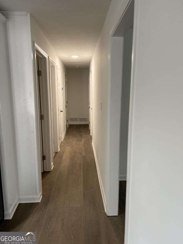 hallway with dark hardwood / wood-style floors