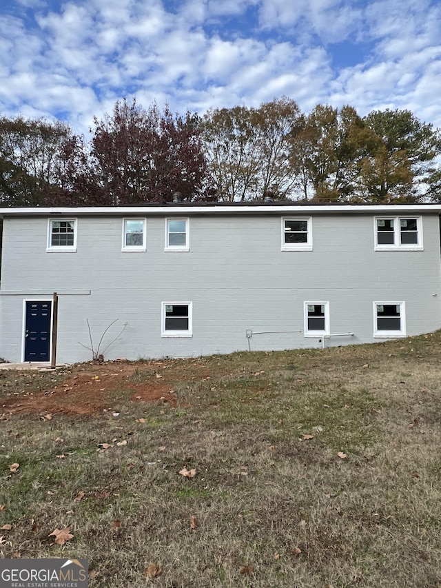 view of side of property with a lawn