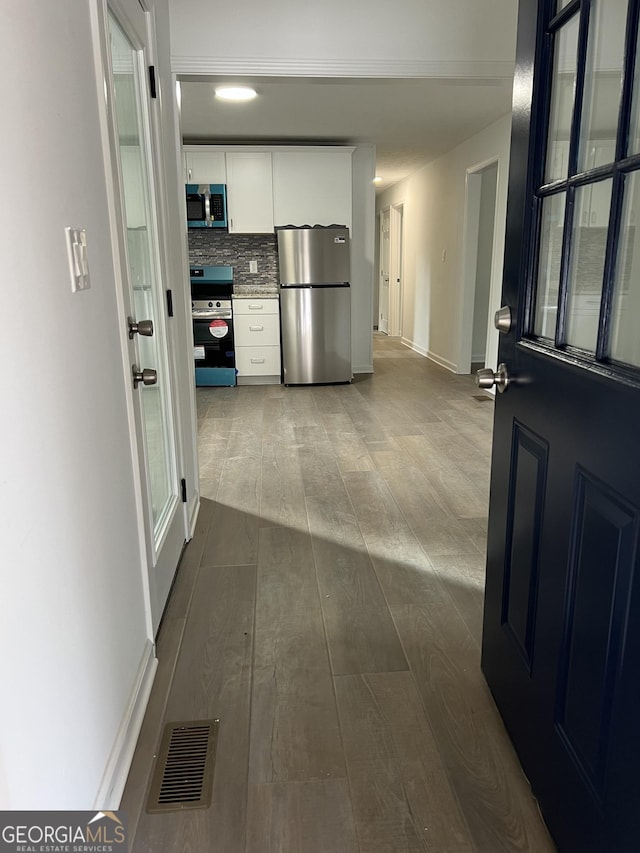 corridor featuring hardwood / wood-style floors