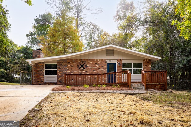 ranch-style house with a wooden deck