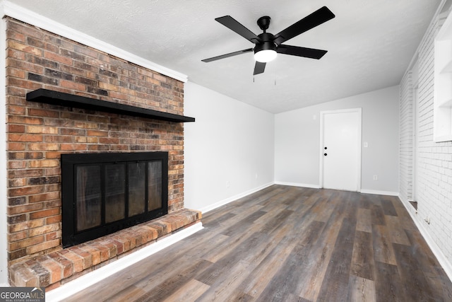 unfurnished living room featuring dark wood-type flooring, vaulted ceiling, ceiling fan, a textured ceiling, and a fireplace