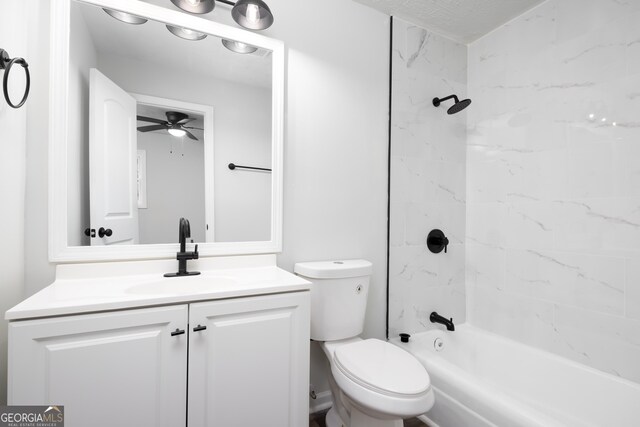 full bathroom featuring toilet, vanity, tiled shower / bath combo, and ceiling fan