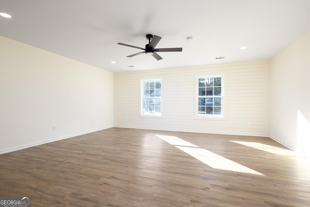 spare room featuring hardwood / wood-style floors and ceiling fan