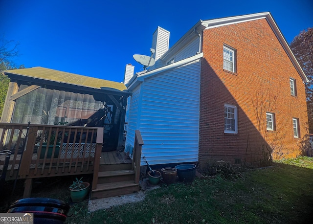 rear view of house featuring a wooden deck