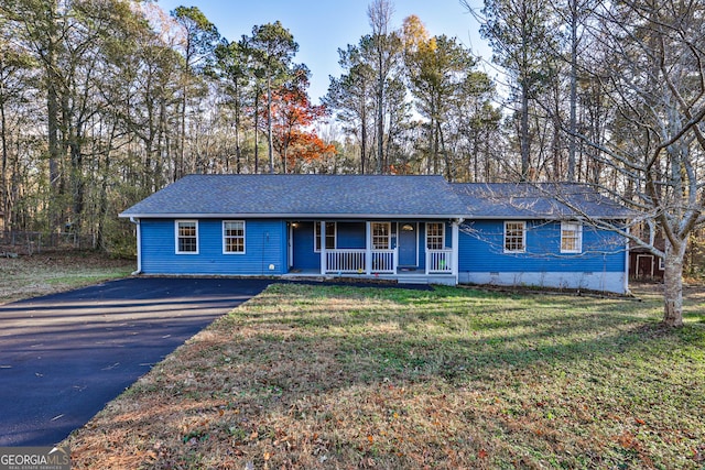 ranch-style home featuring a front lawn and covered porch