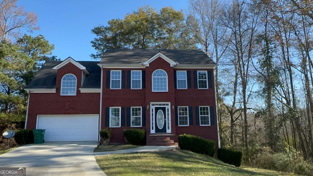 view of front of property with a garage and a front lawn