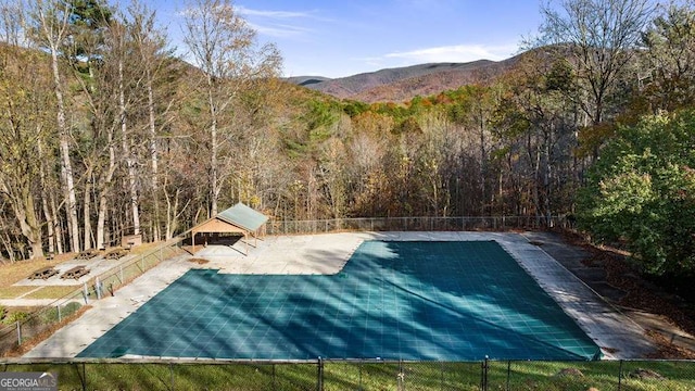 view of swimming pool featuring a gazebo, a mountain view, and a patio