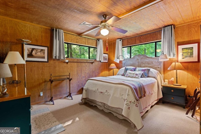 bedroom with ceiling fan, light colored carpet, wooden ceiling, and wooden walls