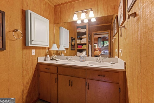 bathroom with vanity and wooden walls