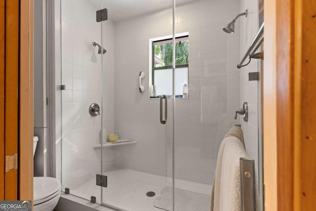 bathroom with toilet and walk in shower