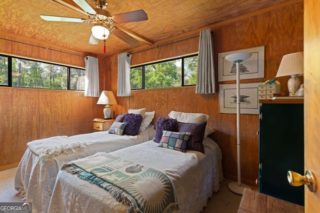 carpeted bedroom with multiple windows, ceiling fan, wooden ceiling, and wood walls