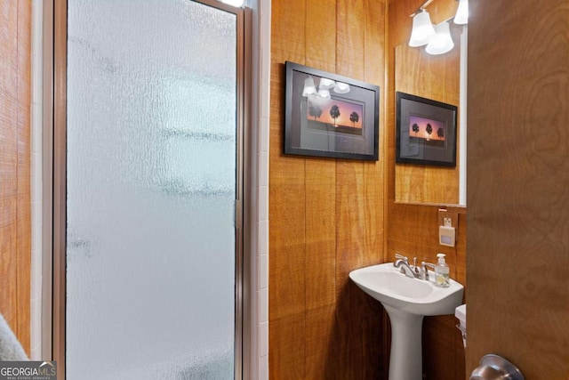 bathroom with walk in shower and wooden walls