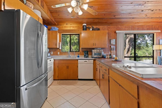 kitchen with ceiling fan, plenty of natural light, white appliances, and sink