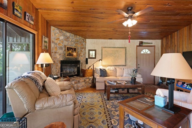 living room with hardwood / wood-style floors, wooden walls, plenty of natural light, and wood ceiling