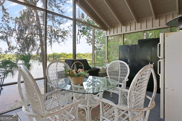 sunroom featuring vaulted ceiling with beams, a water view, and wood ceiling