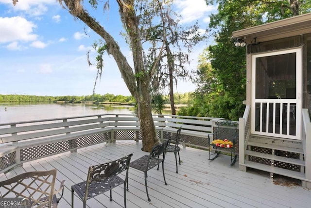 wooden terrace featuring a water view