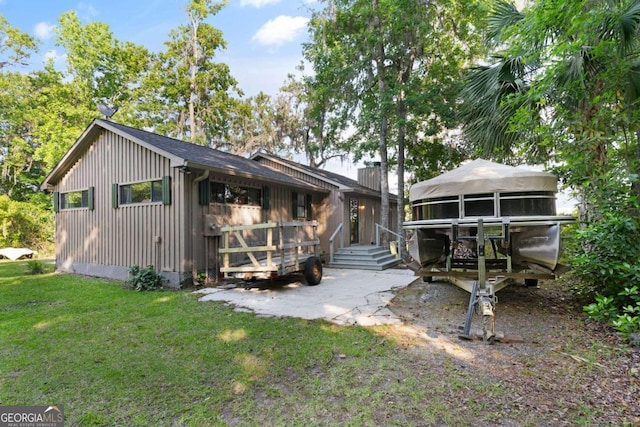 rear view of house with a yard