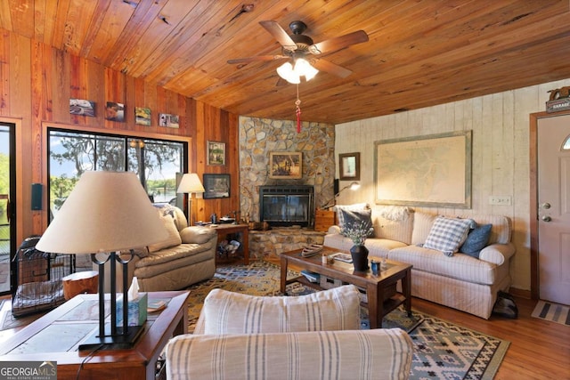 living room with wood ceiling, ceiling fan, hardwood / wood-style floors, lofted ceiling, and wood walls