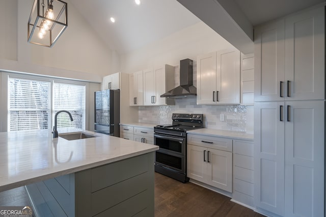 kitchen featuring sink, wall chimney exhaust hood, stainless steel electric range oven, decorative light fixtures, and white cabinetry