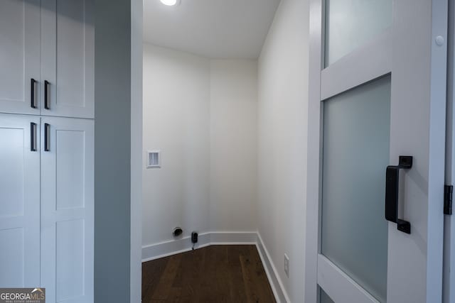 laundry area featuring washer hookup, dark hardwood / wood-style floors, and cabinets