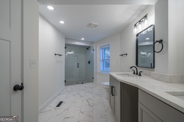 bathroom with vanity, toilet, and a shower with door