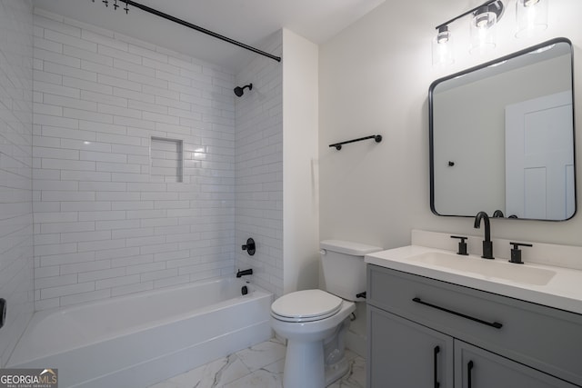 full bathroom with toilet, vanity, and tiled shower / bath