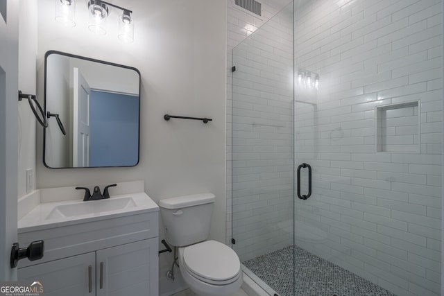 bathroom with vanity, toilet, and walk in shower