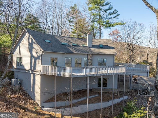 back of property featuring central air condition unit and a wooden deck