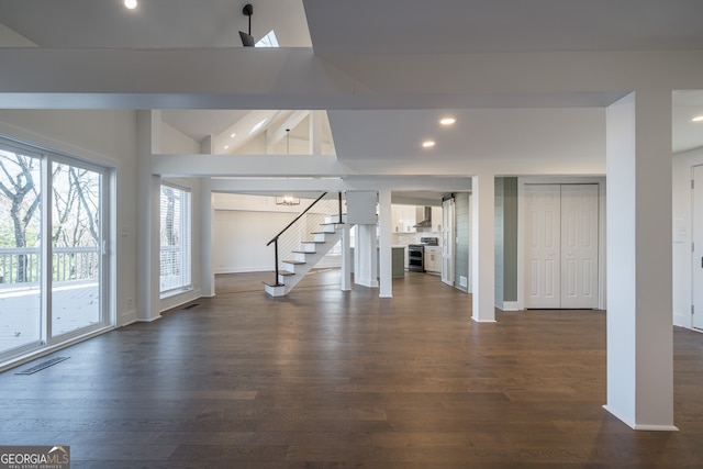 unfurnished living room featuring beam ceiling, high vaulted ceiling, and dark hardwood / wood-style floors