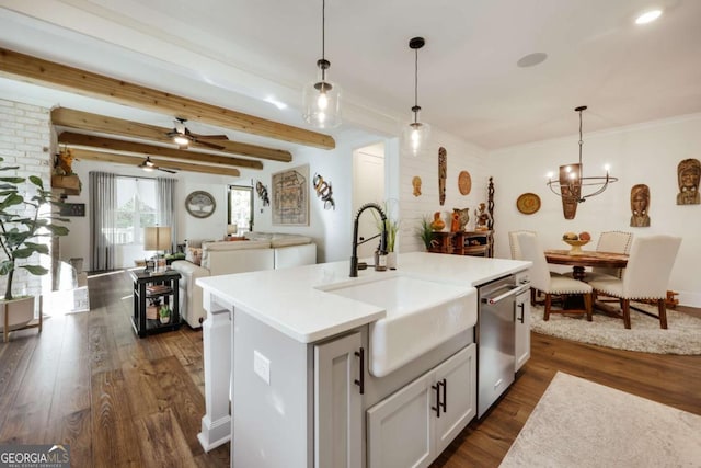 kitchen featuring sink, hanging light fixtures, stainless steel dishwasher, dark hardwood / wood-style floors, and a kitchen island with sink