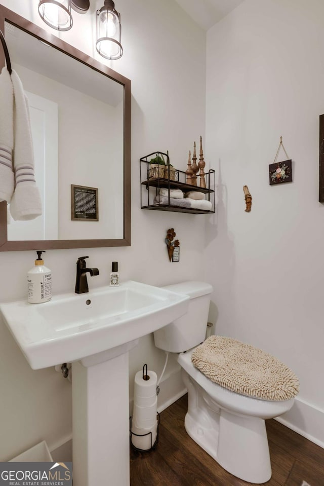 bathroom with sink, wood-type flooring, and toilet