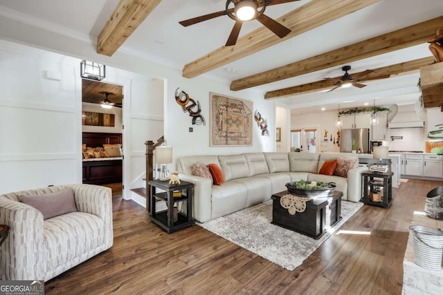 living room featuring beam ceiling and dark wood-type flooring