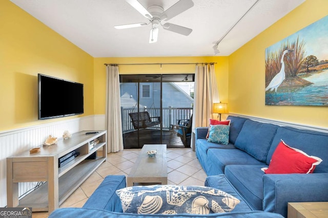 tiled living room with ceiling fan and rail lighting