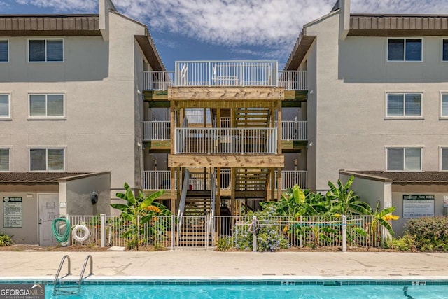 rear view of property featuring a community pool